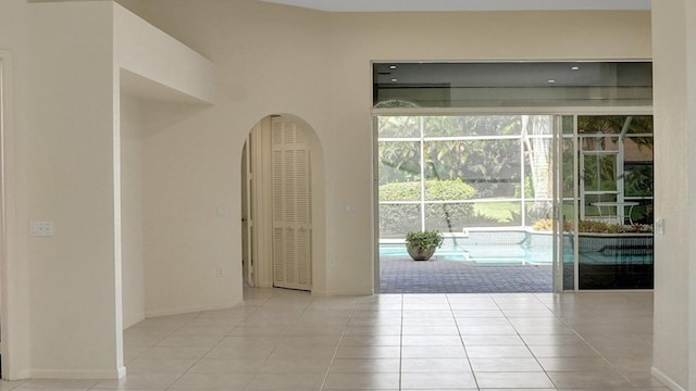 6809 Portside Dr, Boca Raton, FL 33496 - empty room featuring tile patterned floors and arched walkways