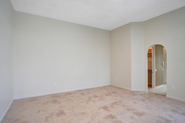 6809 Portside Dr, Boca Raton, FL 33496 - unfurnished room featuring arched walkways and baseboards