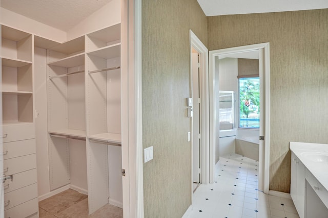 6809 Portside Dr, Boca Raton, FL 33496 - bathroom featuring wallpapered walls, tile patterned floors, vanity, and a spacious closet
