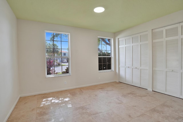 6809 Portside Dr, Boca Raton, FL 33496 - unfurnished bedroom featuring tile patterned flooring and two closets