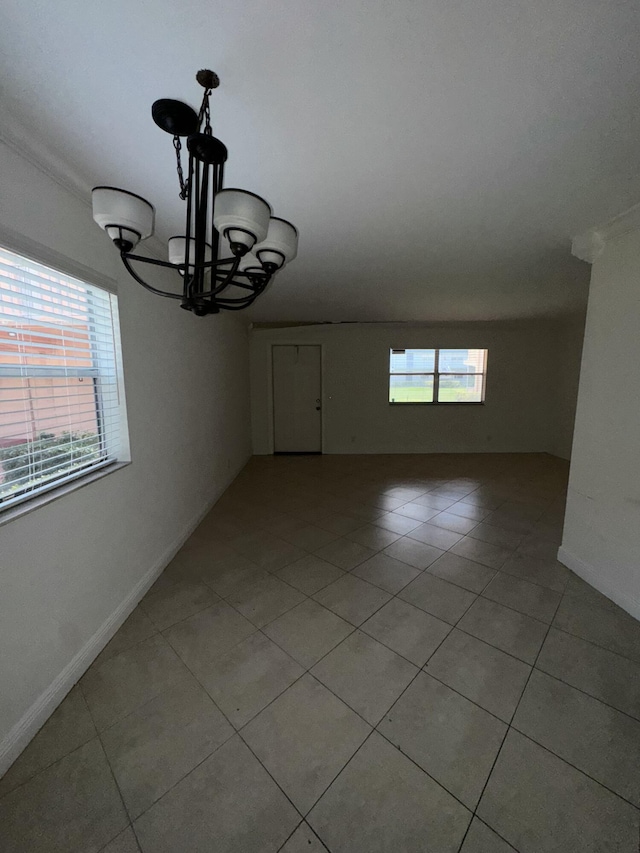 638 Saxony N, Delray Beach, FL 33446 - empty room featuring a chandelier and light tile patterned floors