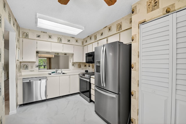 7290 Ashford Pl Unit 201, Delray Beach, FL 33446 - kitchen with appliances with stainless steel finishes, light countertops, a textured ceiling, light marble finish floors, and white cabinets