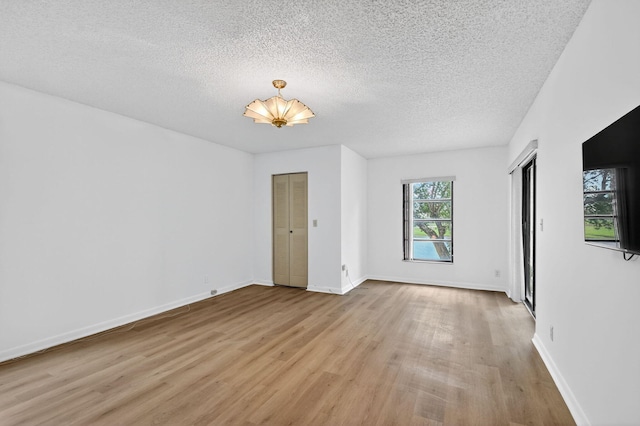7290 Ashford Pl Unit 201, Delray Beach, FL 33446 - unfurnished room featuring light wood-style floors and a textured ceiling