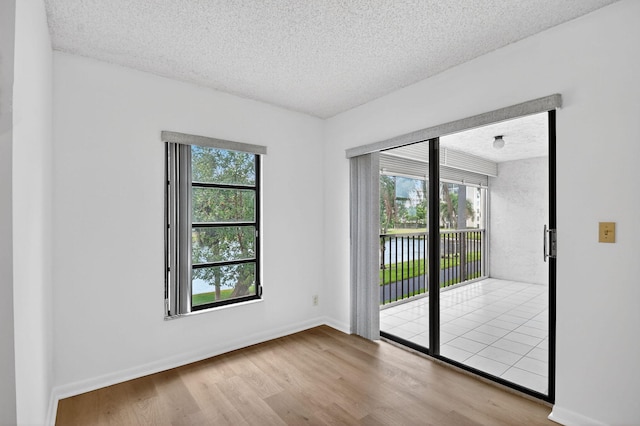 7290 Ashford Pl Unit 201, Delray Beach, FL 33446 - empty room with wood finished floors and a textured ceiling