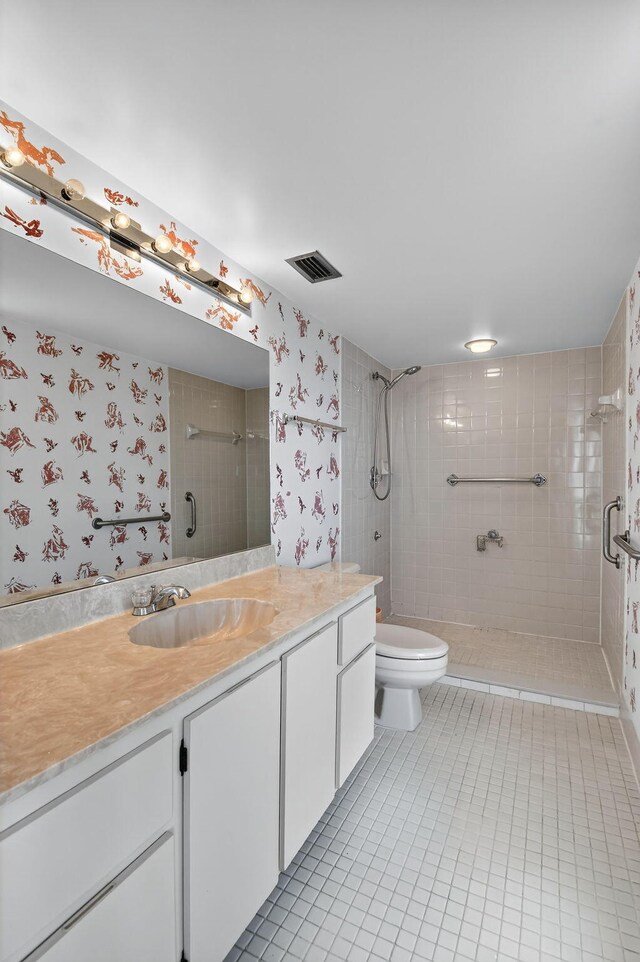7290 Ashford Pl Unit 201, Delray Beach, FL 33446 - bathroom with tile patterned floors, a shower stall, vanity, and wallpapered walls