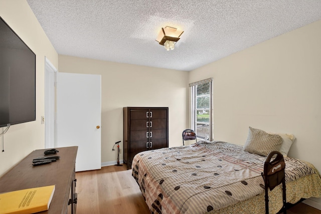 7290 Ashford Pl Unit 201, Delray Beach, FL 33446 - bedroom with light wood-type flooring and a textured ceiling