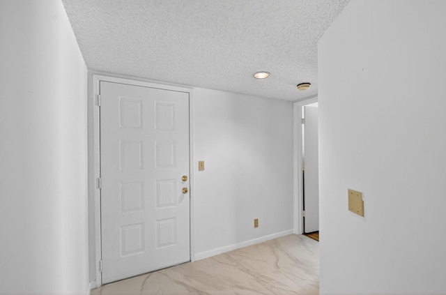 7290 Ashford Pl Unit 201, Delray Beach, FL 33446 - foyer with a textured ceiling and light marble finish flooring