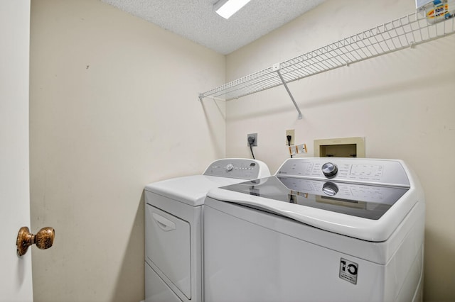 7290 Ashford Pl Unit 201, Delray Beach, FL 33446 - laundry room featuring separate washer and dryer and a textured ceiling