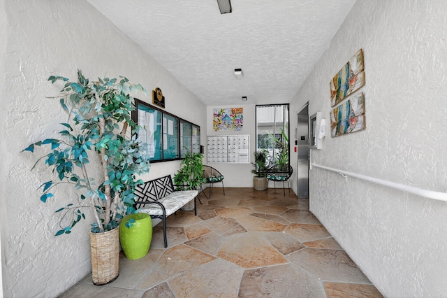 7290 Ashford Pl Unit 201, Delray Beach, FL 33446 - hall with stone floors, a textured ceiling, and a textured wall