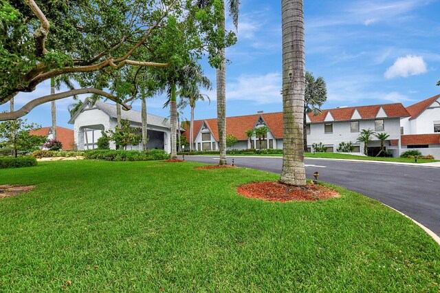 7290 Ashford Pl Unit 201, Delray Beach, FL 33446 - view of grassy yard with driveway