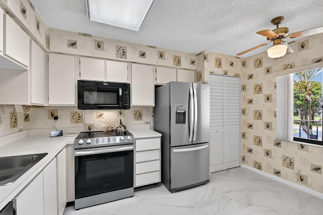 7290 Ashford Pl Unit 201, Delray Beach, FL 33446 - kitchen with appliances with stainless steel finishes, wallpapered walls, light countertops, a textured ceiling, and light marble finish floors