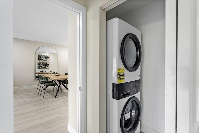 20 Southport Ln Unit D, Boynton Beach, FL 33436 - laundry area featuring stacked washer / drying machine and light wood-style floors