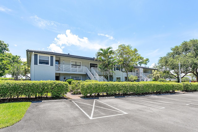 20 Southport Ln Unit D, Boynton Beach, FL 33436 - view of property with uncovered parking and stairs