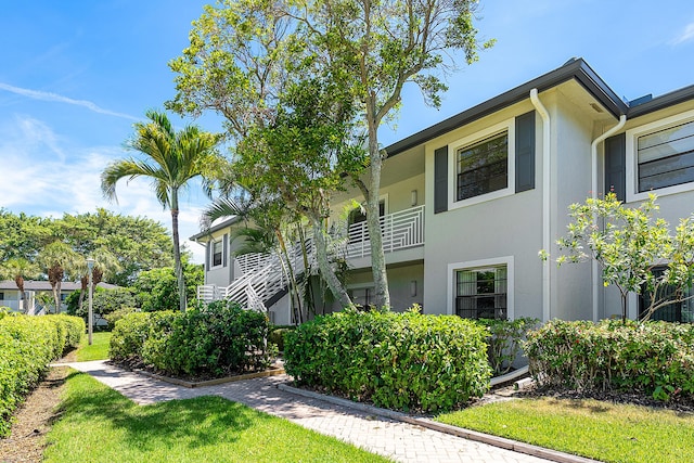 20 Southport Ln Unit D, Boynton Beach, FL 33436 - view of side of home featuring stucco siding