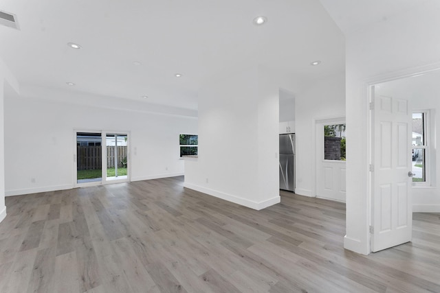 23157 Old Inlet Bridge Dr, Boca Raton, FL 33433 - unfurnished living room featuring light wood-style flooring and recessed lighting