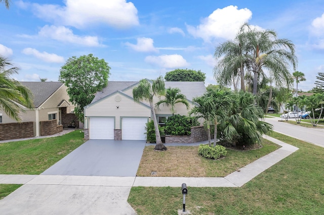23157 Old Inlet Bridge Dr, Boca Raton, FL 33433 - view of property hidden behind natural elements featuring concrete driveway, a front yard, and an attached garage