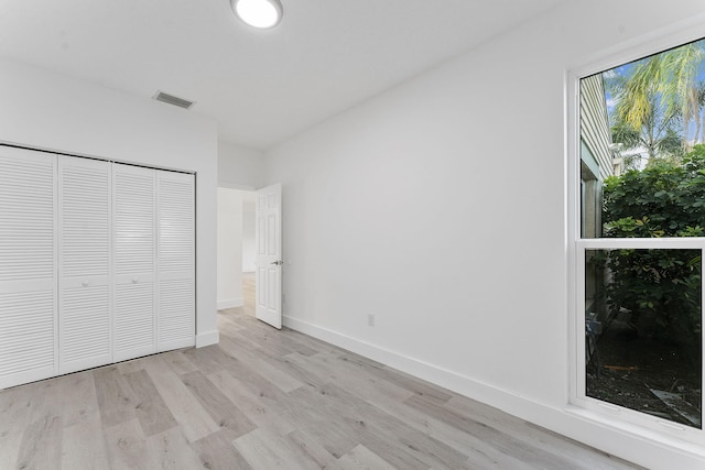 23157 Old Inlet Bridge Dr, Boca Raton, FL 33433 - unfurnished bedroom with light wood finished floors and a closet
