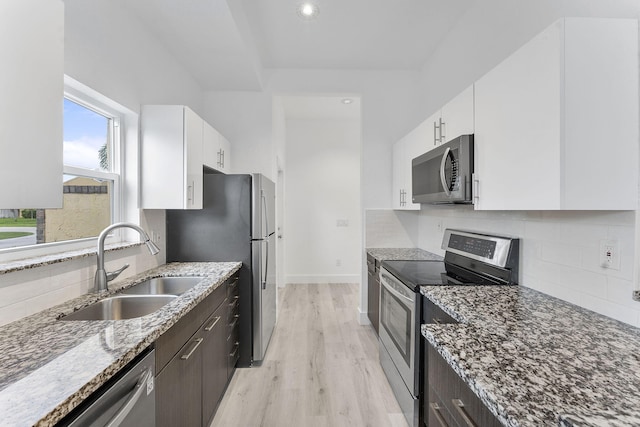 23157 Old Inlet Bridge Dr, Boca Raton, FL 33433 - kitchen with stainless steel appliances, white cabinets, stone countertops, light wood-type flooring, and recessed lighting