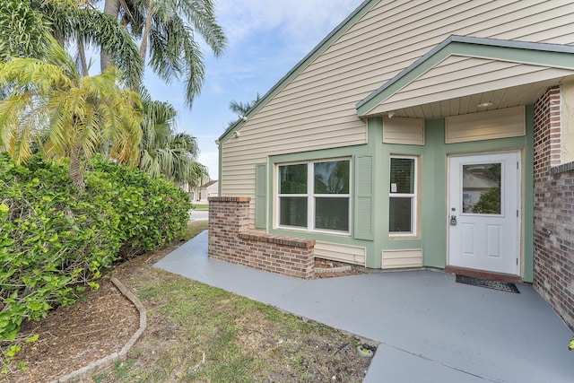23157 Old Inlet Bridge Dr, Boca Raton, FL 33433 - doorway to property featuring brick siding and a patio area