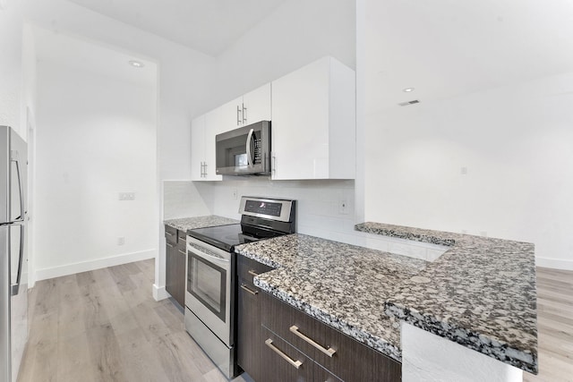 23157 Old Inlet Bridge Dr, Boca Raton, FL 33433 - kitchen with appliances with stainless steel finishes, light stone countertops, white cabinets, and light wood-style flooring
