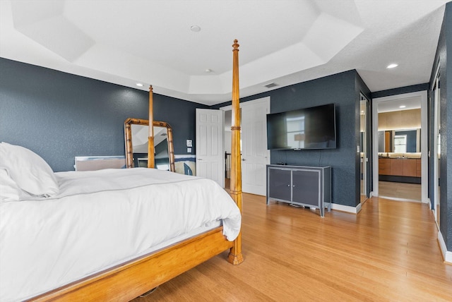 19335 Skyridge Cir, Boca Raton, FL 33498 - bedroom featuring a raised ceiling, wood finished floors, a textured wall, and recessed lighting