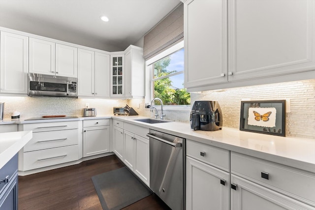 19335 Skyridge Cir, Boca Raton, FL 33498 - kitchen featuring stainless steel appliances, tasteful backsplash, white cabinetry, glass insert cabinets, and dark wood-type flooring