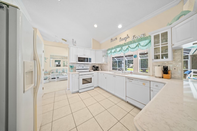 1104 SE Strathmore Dr, Port Saint Lucie, FL 34952 - kitchen featuring white appliances, ornamental molding, backsplash, light tile patterned floors, and white cabinets