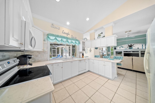 1104 SE Strathmore Dr, Port Saint Lucie, FL 34952 - kitchen featuring electric range, dishwasher, ornamental molding, light tile patterned flooring, and a peninsula