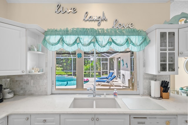 1104 SE Strathmore Dr, Port Saint Lucie, FL 34952 - kitchen with white cabinets and decorative backsplash