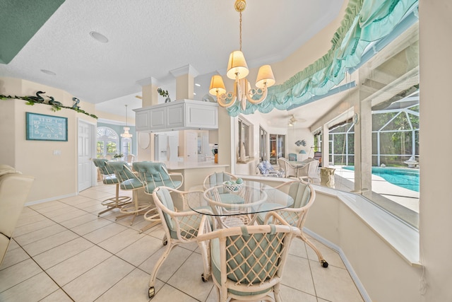 1104 SE Strathmore Dr, Port Saint Lucie, FL 34952 - dining space with a chandelier, plenty of natural light, light tile patterned floors, and a textured ceiling