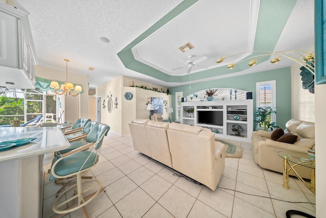 1104 SE Strathmore Dr, Port Saint Lucie, FL 34952 - living area featuring a textured ceiling, light tile patterned floors, a chandelier, a ceiling fan, and a raised ceiling