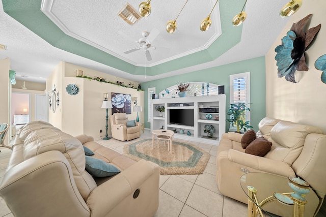 1104 SE Strathmore Dr, Port Saint Lucie, FL 34952 - living room with light tile patterned floors, a tray ceiling, a textured ceiling, and ceiling fan