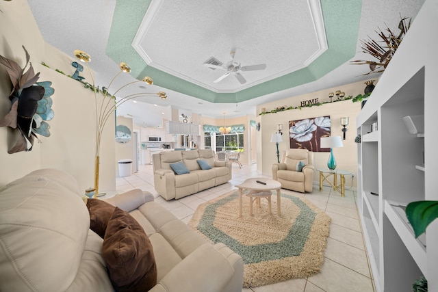 1104 SE Strathmore Dr, Port Saint Lucie, FL 34952 - living area featuring a raised ceiling, ceiling fan, a textured ceiling, light tile patterned floors, and crown molding