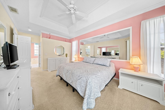 1104 SE Strathmore Dr, Port Saint Lucie, FL 34952 - bedroom featuring a tray ceiling, light colored carpet, crown molding, ensuite bathroom, and ceiling fan