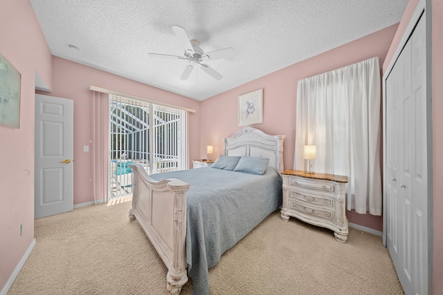 1104 SE Strathmore Dr, Port Saint Lucie, FL 34952 - bedroom with light carpet, a textured ceiling, a closet, access to outside, and ceiling fan