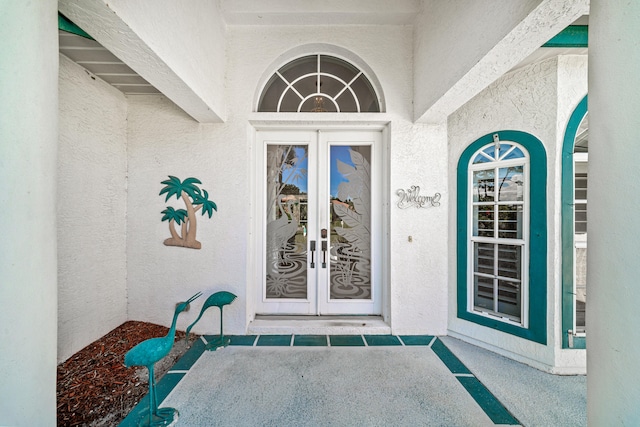 1104 SE Strathmore Dr, Port Saint Lucie, FL 34952 - view of exterior entry with french doors and stucco siding