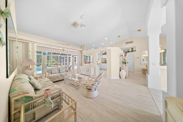 1104 SE Strathmore Dr, Port Saint Lucie, FL 34952 - living area with vaulted ceiling, wood finished floors, decorative columns, and arched walkways