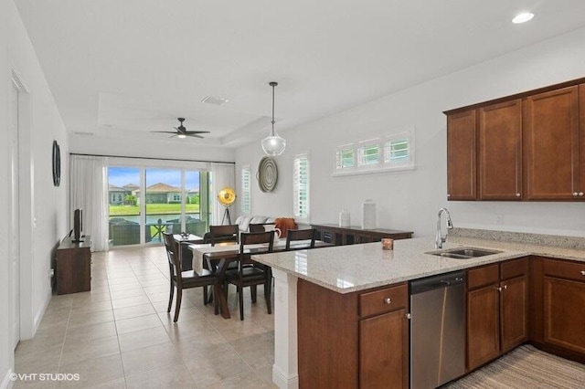 9155 SW Michele Way, Port Saint Lucie, FL 34987 - kitchen featuring dishwasher, light stone countertops, ceiling fan, light tile patterned flooring, and a peninsula