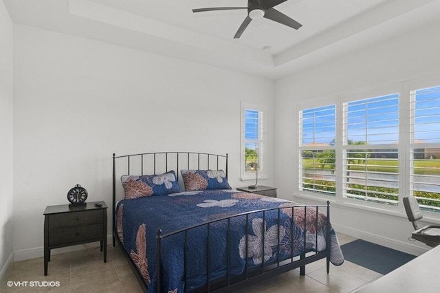 9155 SW Michele Way, Port Saint Lucie, FL 34987 - tiled bedroom with a tray ceiling and ceiling fan
