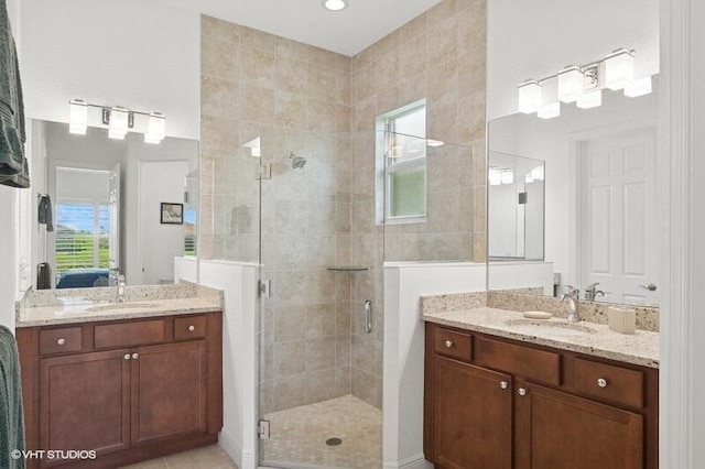 9155 SW Michele Way, Port Saint Lucie, FL 34987 - bathroom featuring a shower stall, two vanities, and ensuite bathroom