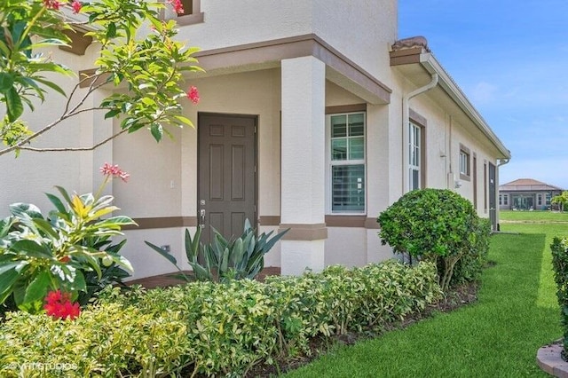 9155 SW Michele Way, Port Saint Lucie, FL 34987 - view of exterior entry featuring stucco siding