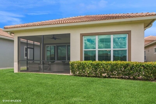 9155 SW Michele Way, Port Saint Lucie, FL 34987 - rear view of house featuring a tile roof, a yard, ceiling fan, stucco siding, and a sunroom