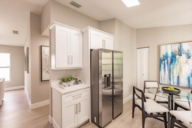 8008 Red Reef Ln, Boynton Beach, FL 33436 - kitchen featuring stainless steel fridge with ice dispenser, light wood-style floors, white cabinets, and light countertops