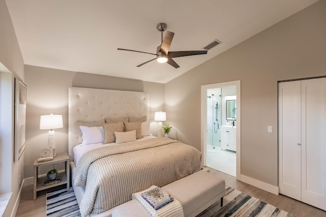8008 Red Reef Ln, Boynton Beach, FL 33436 - bedroom with light wood-type flooring, vaulted ceiling, connected bathroom, and ceiling fan