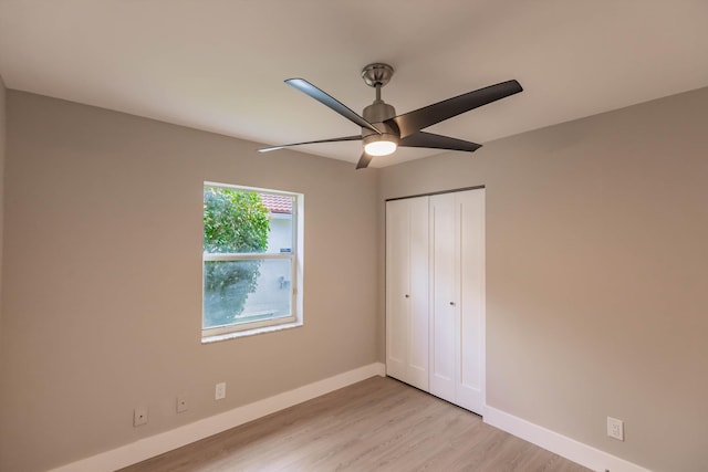 8008 Red Reef Ln, Boynton Beach, FL 33436 - unfurnished bedroom with light wood-type flooring, a closet, and ceiling fan