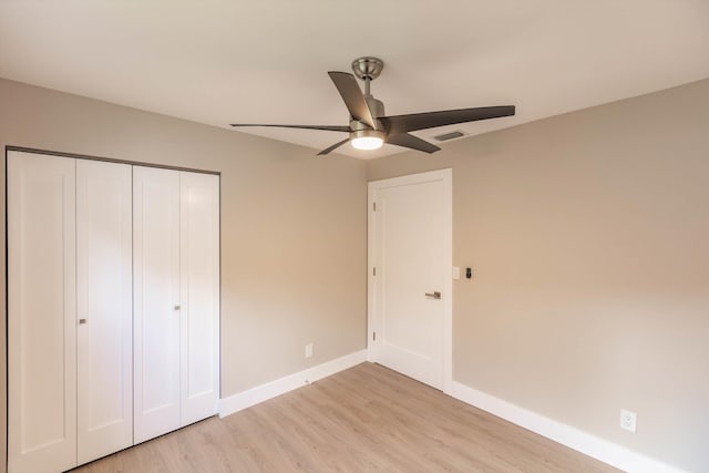 8008 Red Reef Ln, Boynton Beach, FL 33436 - unfurnished bedroom with light wood-style floors, a closet, and ceiling fan