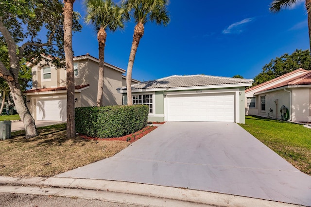 8008 Red Reef Ln, Boynton Beach, FL 33436 - view of front of home featuring stucco siding, driveway, a tile roof, and a front lawn