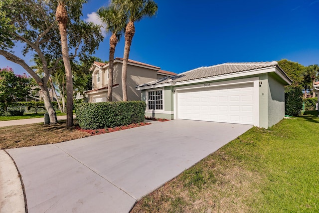 8008 Red Reef Ln, Boynton Beach, FL 33436 - view of front of house featuring an attached garage, a tiled roof, stucco siding, concrete driveway, and a front yard
