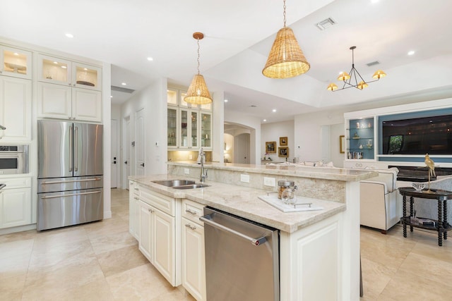 216 Summa St, West Palm Beach, FL 33405 - kitchen with stainless steel appliances, open floor plan, light stone countertops, hanging light fixtures, and recessed lighting