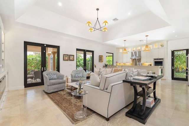 216 Summa St, West Palm Beach, FL 33405 - living area featuring french doors, a chandelier, light tile patterned flooring, healthy amount of natural light, and recessed lighting